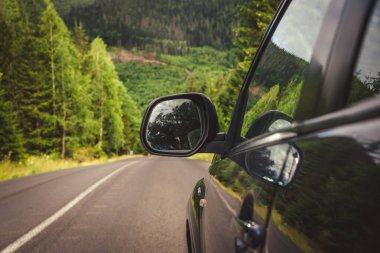 car for traveling with a mountain road. Dramatic sky