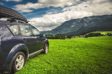 car for traveling with a mountain road. Dramatic sky