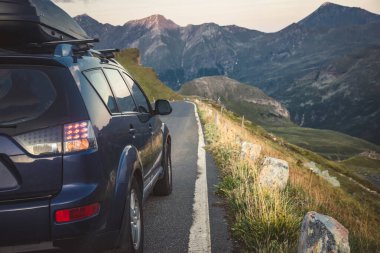 car for traveling with a mountain road. Dramatic sky