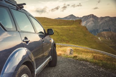 car for traveling with a mountain road. Dramatic sky