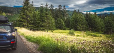 car for traveling with a mountain road. Dramatic sky