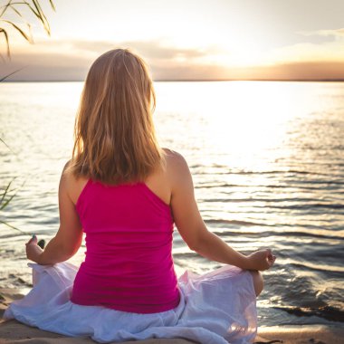 Denizde dinginlik ve yoga pratiği. gün batımı