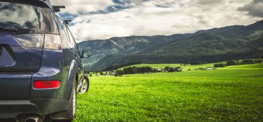 car for traveling with a mountain road. Dramatic sky