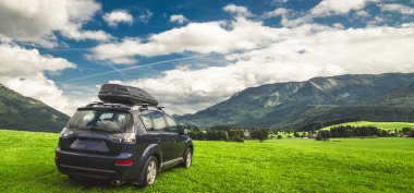 car for traveling with a mountain road. Dramatic sky