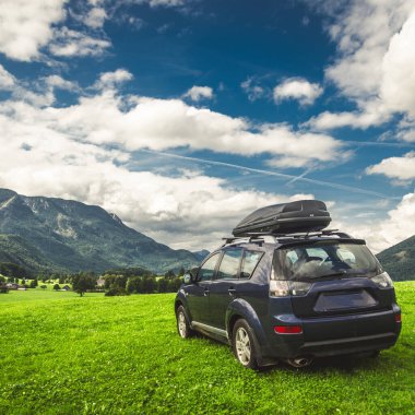 car for traveling with a mountain road. Dramatic sky