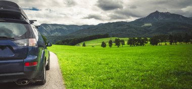 car for traveling with a mountain road. Dramatic sky
