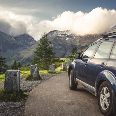 car for traveling with a mountain road. Dramatic sky