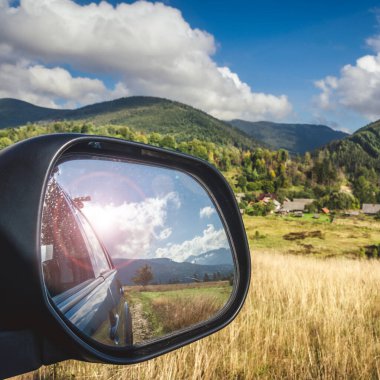 car for traveling with a mountain road. Dramatic sky