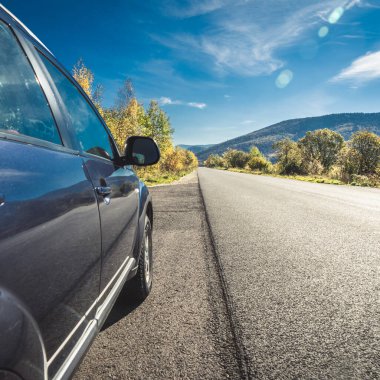 car for traveling with a mountain road. Dramatic sky