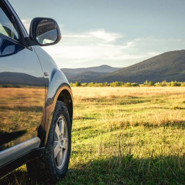 Woman in white bathrobe lying on sofa and relaxing with orange cocktail at the roof of hotel