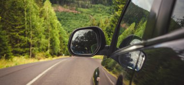 Woman in white bathrobe lying on sofa and relaxing with orange cocktail at the roof of hotel