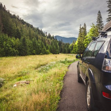 Woman in white bathrobe lying on sofa and relaxing with orange cocktail at the roof of hotel