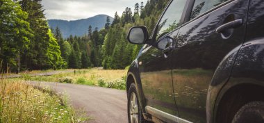 Woman in white bathrobe lying on sofa and relaxing with orange cocktail at the roof of hotel