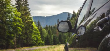 Woman in white bathrobe lying on sofa and relaxing with orange cocktail at the roof of hotel