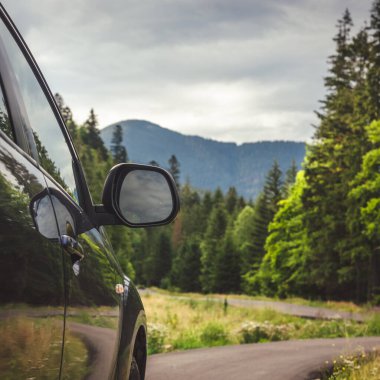 Woman in white bathrobe lying on sofa and relaxing with orange cocktail at the roof of hotel