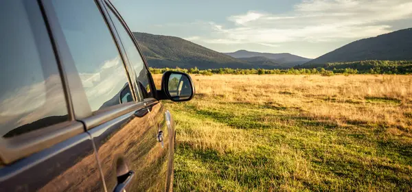 Woman in white bathrobe lying on sofa and relaxing with orange cocktail at the roof of hotel