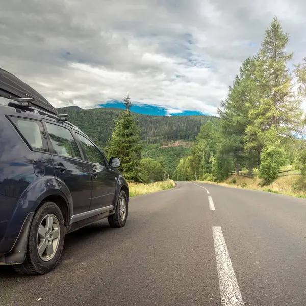 Woman in white bathrobe lying on sofa and relaxing with orange cocktail at the roof of hotel