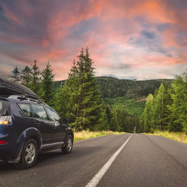 Woman in white bathrobe lying on sofa and relaxing with orange cocktail at the roof of hotel