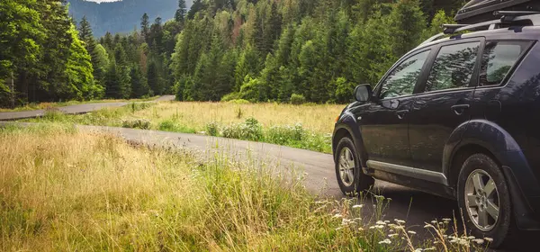 Woman in white bathrobe lying on sofa and relaxing with orange cocktail at the roof of hotel