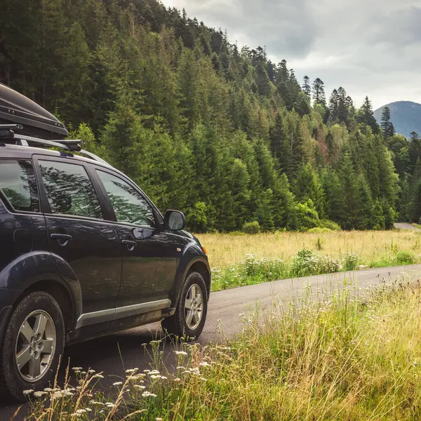 Woman in white bathrobe lying on sofa and relaxing with orange cocktail at the roof of hotel