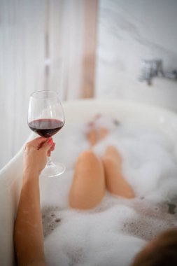 Kırmızı ayakkabılı ve bir bardak şaraplı kadın bacakları, otel.