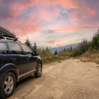 car for traveling with a mountain road. Dramatic sky
