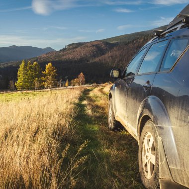 car for traveling with a mountain road. Dramatic sky