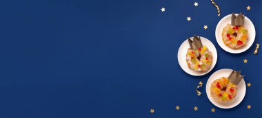 Geleneksel krallar, mavi arka planda, kış süslemeleri ile birlikte, her gün yapılan Epifani pastalar. Roscon de Reyes, İspanyol üç kral Noel pastası. Epifani Günü 'nün tipik İspanyol tatlısı..