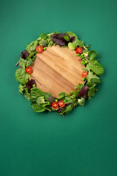 Stock image Vegetarian and vegan diet month in january called Veganuary. Variety of vegan, plant based protein food, healthy raw vegetables. Top view on green background.