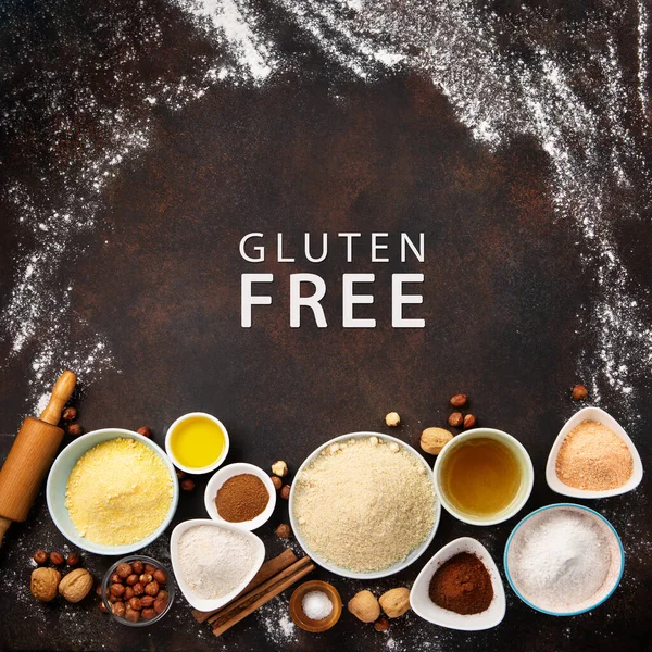 Ingredients for gluten free cookies or bread. Healthy eating, dieting, balanced food concept. Cereals gluten-free, millet, quinoa, almond, buckwheat, spices, honey on brown background. Ancient grain food.
