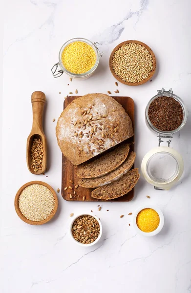 Ancient grain food. Bread Gluten free, Healthy eating, dieting, balanced food concept. Cereals gluten-free, millet, quinoa, polenta, buckwheat, flax seeds, sunflower seeds on white background.
