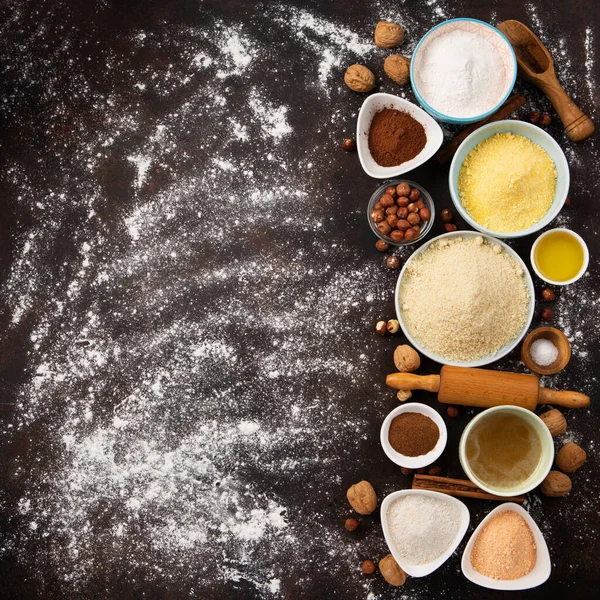 Ingredients for gluten free cookies or bread. Healthy eating, dieting, balanced food concept. Cereals gluten-free, millet, quinoa, almond, buckwheat, spices, honey on brown background. Ancient grain food.