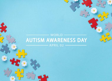 World Autism Awareness Day or month concept. Creative design for April 2. Color puzzle, symbol of awareness for autism spectrum disorder and daisy flowers on blue background. Top view, copy space for text.  clipart