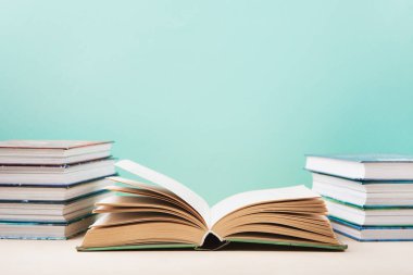 Dünya kitabı ve telif hakkı günü, eğitim konsepti. Mavi nane arkaplanıyla ilgili yığınla kitap. Kitaplar için bayram kartı, kopyalama alanı.
