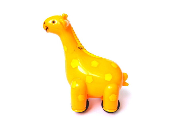 Giraffe toy isolated on white background. Close up of orange color plastic toy, kids toy.