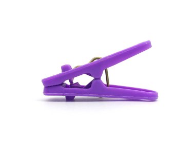 Plastic clothes pin isolated on white background. Close up of purple clothes peg.