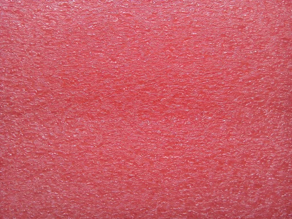 Red foam sheet texture background.