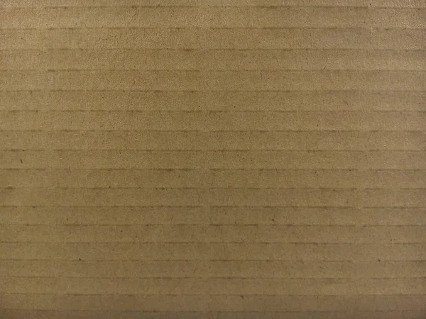 Brown paper cardboard texture background. Close up of cardboard sheet.