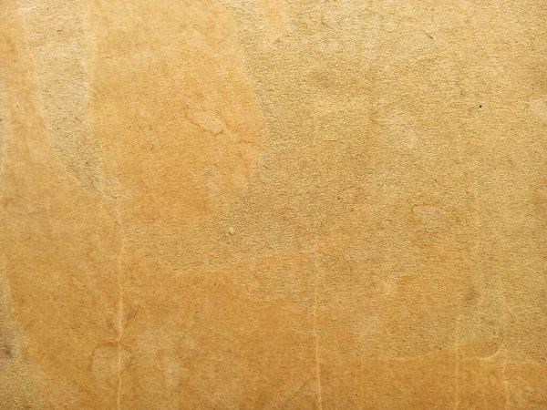 Grunge cardboard paper texture background. Close up of stain on old brown corrugated cardboard.