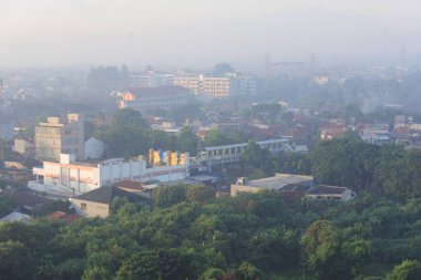View of a residential area in the foggy morning due to air pollution in Bekasi, East Jakarta, Indonesia.