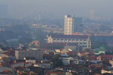 View of a residential area in the foggy morning due to air pollution in Bekasi, East Jakarta, Indonesia.