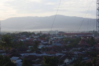 View of rows of houses and buildings in the city of Padang in the morning and a little fog, West Sumatra, Indonesia on May 16, 2022