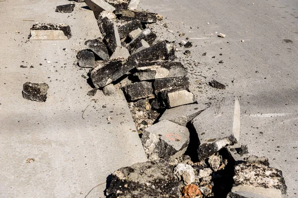 stock image Asphalt road under repairs, lifting the old and broken black asphalt blocks.