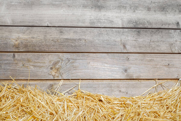 Empty space on wooden table with straw floor for background.