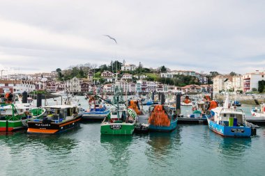 Saint Jean de Luz, France - December 29, 2022: Fishing port with moored fishing boats a calm sunny day in Saint-Jean-de-Luz, France.