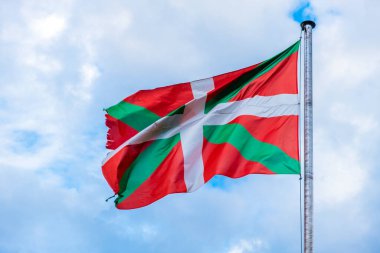 Basque country flag waving against a sky. clipart