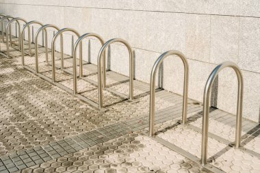 Bars to park  bicycles, empty, installed at the entrance of a building.