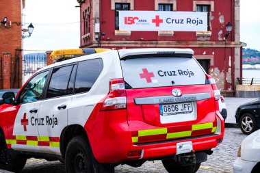 Oviedo, İspanya - 30 Mart 2024 İspanya Kızılhaç karargahının önüne park edilmiş kırmızı bir acil durum aracı.