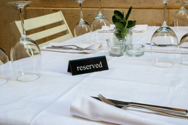 Reserved label on the table of an outdoor restaurant in an Italian city