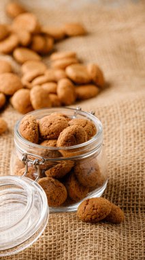 Hollanda bayramı Sinterklaas geleneksel kruidnoten kurabiyeleri çuvaldaki cam kavanozda. Pepernoten, geleneksel tatlılar, strooigoed. Aziz Niklas Günü kavramı. Hikaye şablonu ve telefon arkaplan biçimi